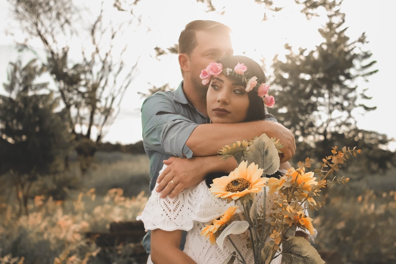 a bride and groom embracing in nature