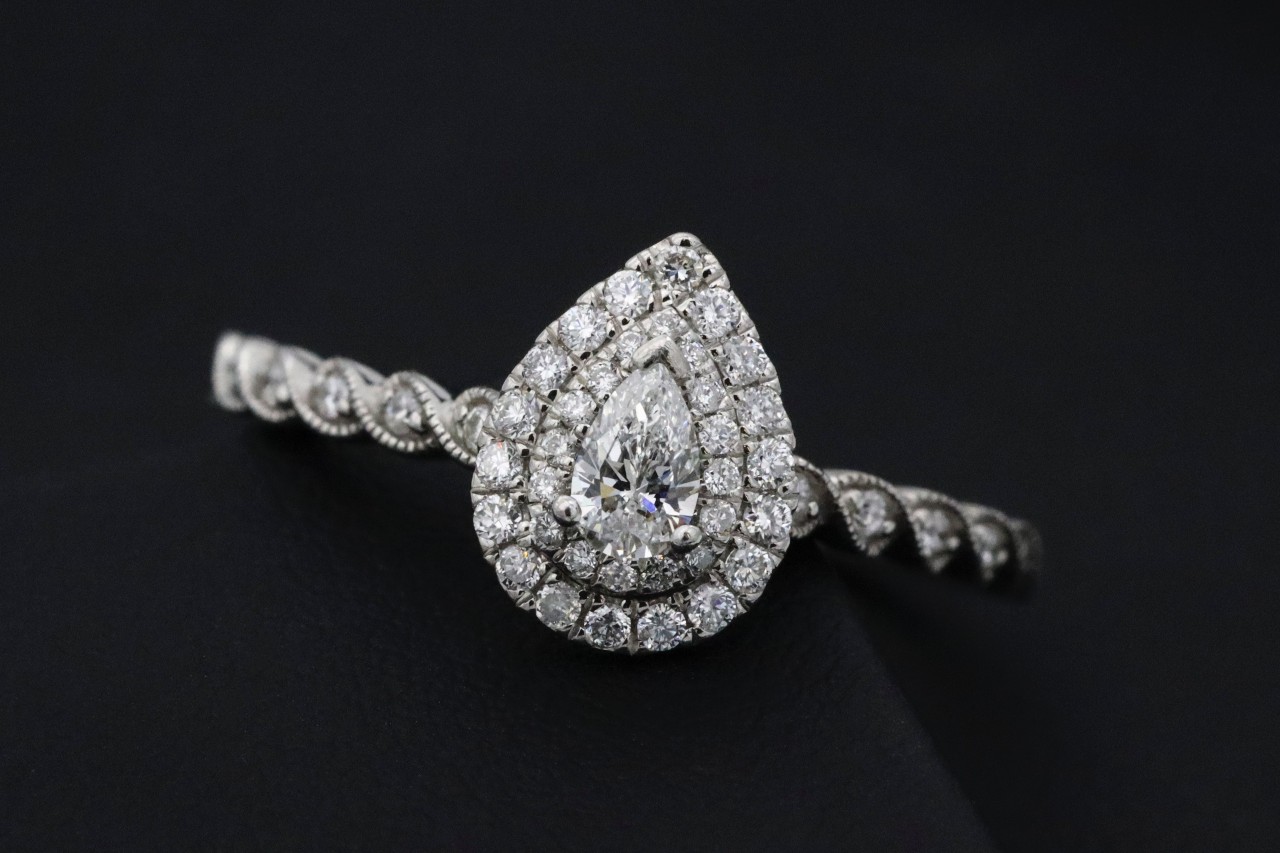 a pear shape halo diamond engagement ring