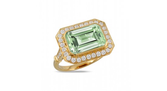 a yellow gold fashion ring featuring a green gemstone