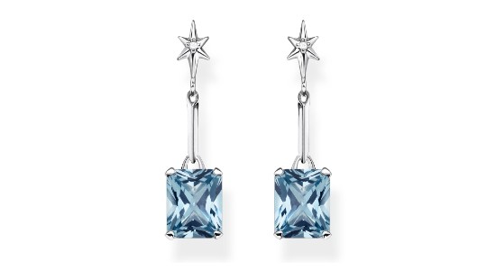 a pair of silver toned star and blue gemstone drop earrings