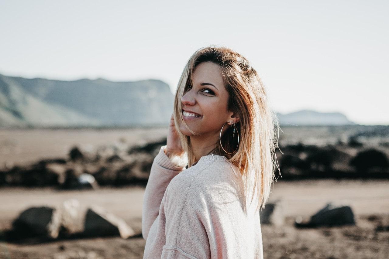 Fashionable lady in the desert showing off her gold hoops