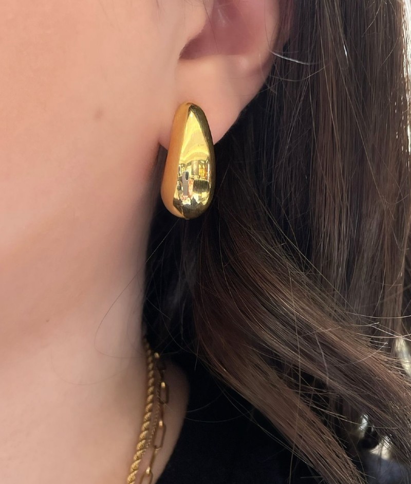 Gold 70s style earrings at Damiani Jewellers