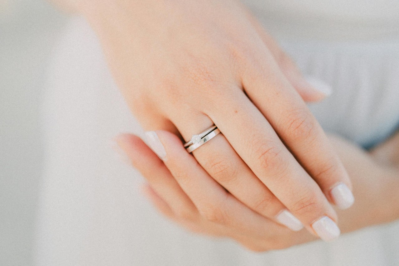 a bride wearing a matching engagement ring and wedding band. a bride wearing a matching engagement ring and wedding band.