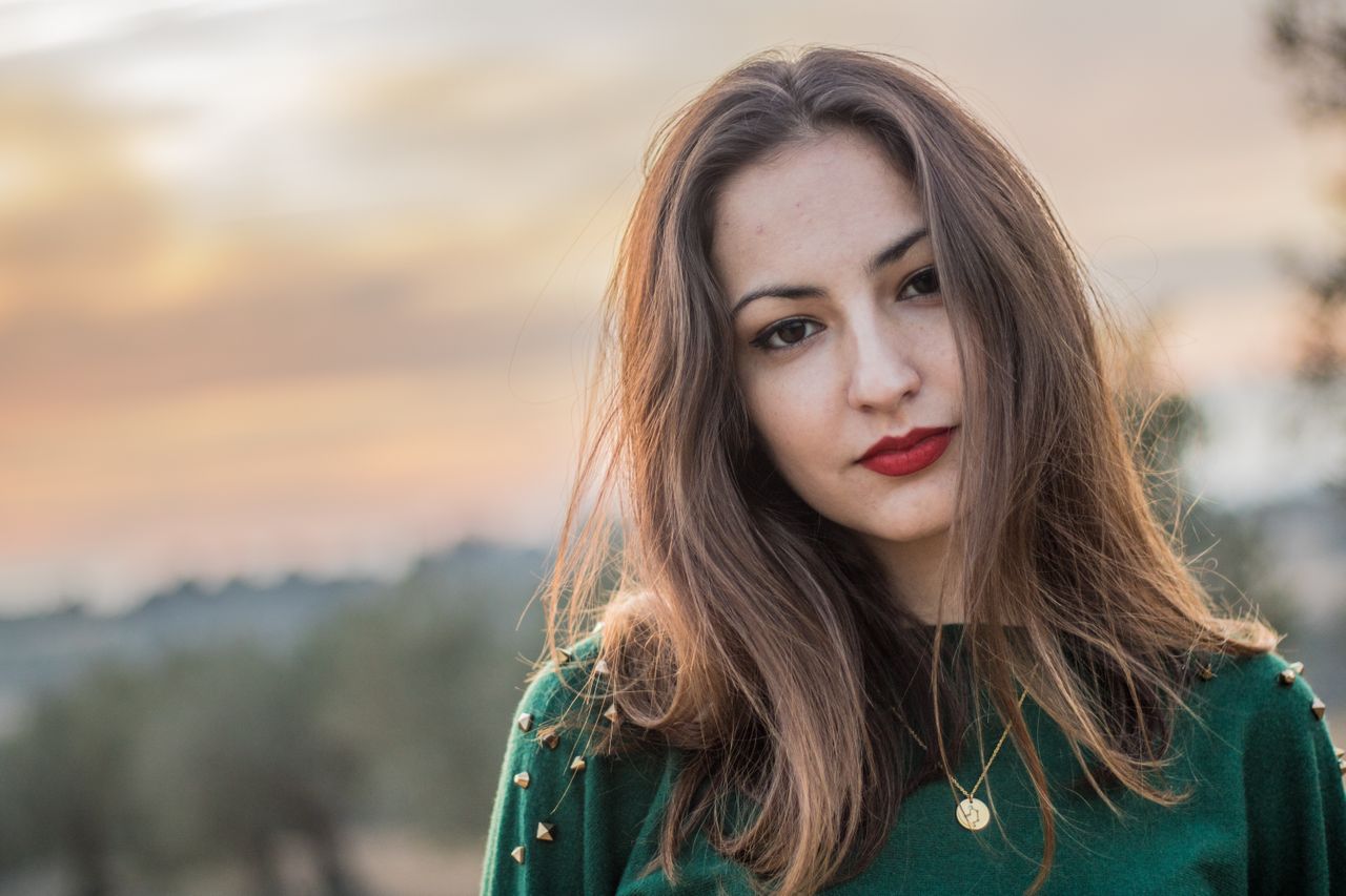 beautiful gold necklace on woman in green sweater beautiful gold necklace on woman in green sweater