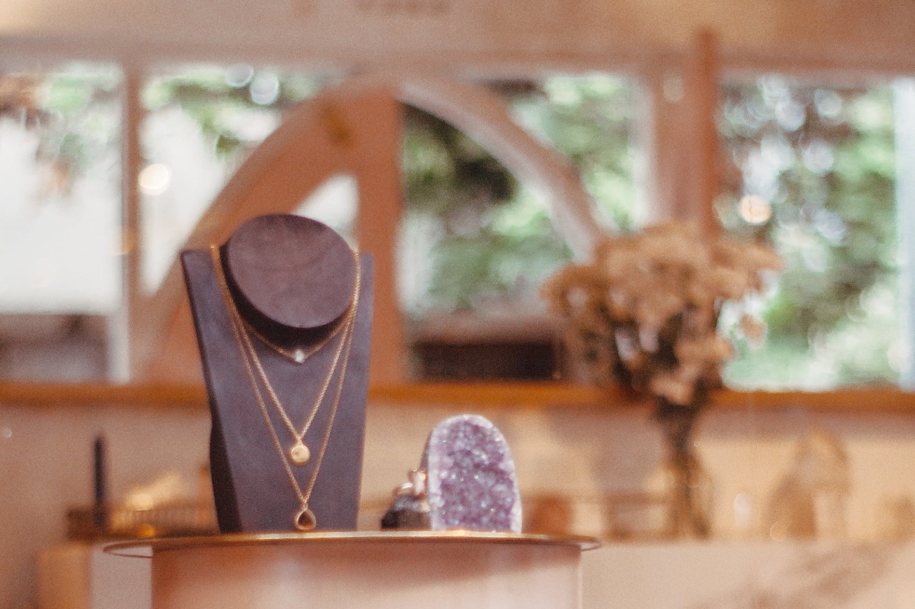 A display showing off a trio of necklaces in a jewellery store.