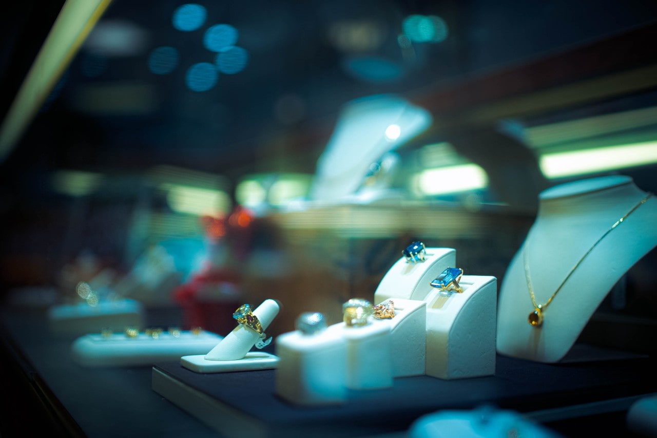 A look inside a glass case inside a jewellery store, showcasing gemstone pieces.